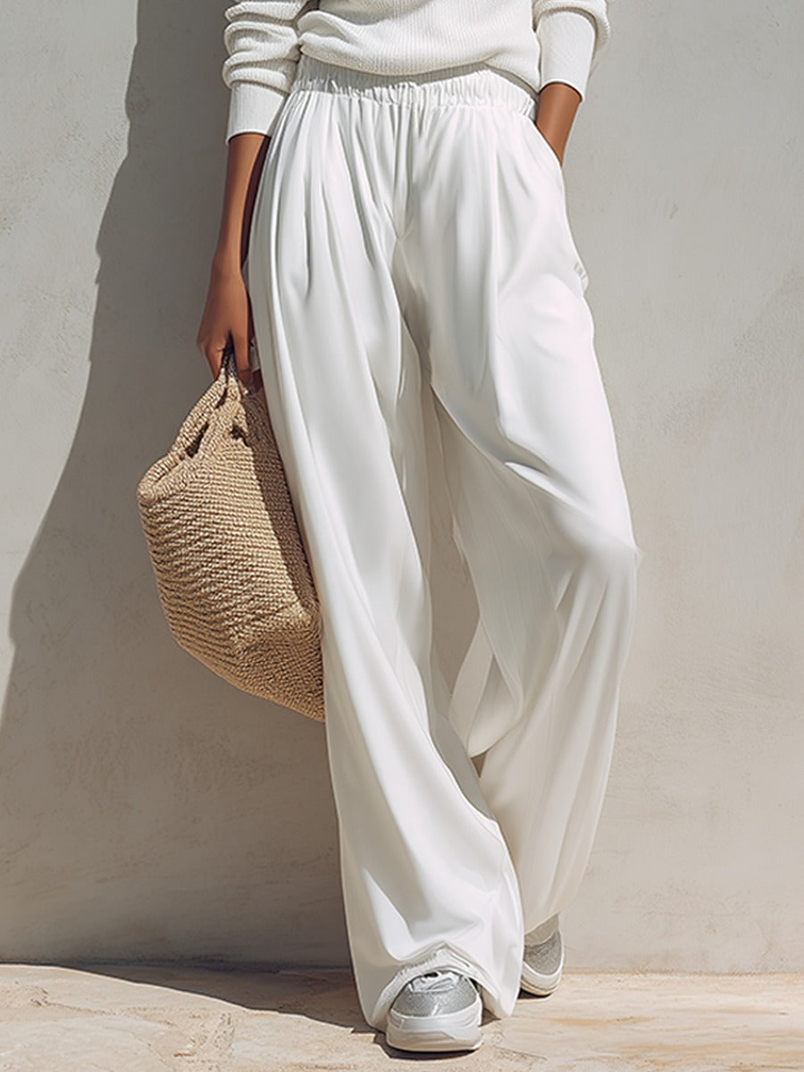 A woman wearing the Adele two-piece set by Bennett and Lowe, featuring a one-shoulder top and wide-leg pants in a stylish design.