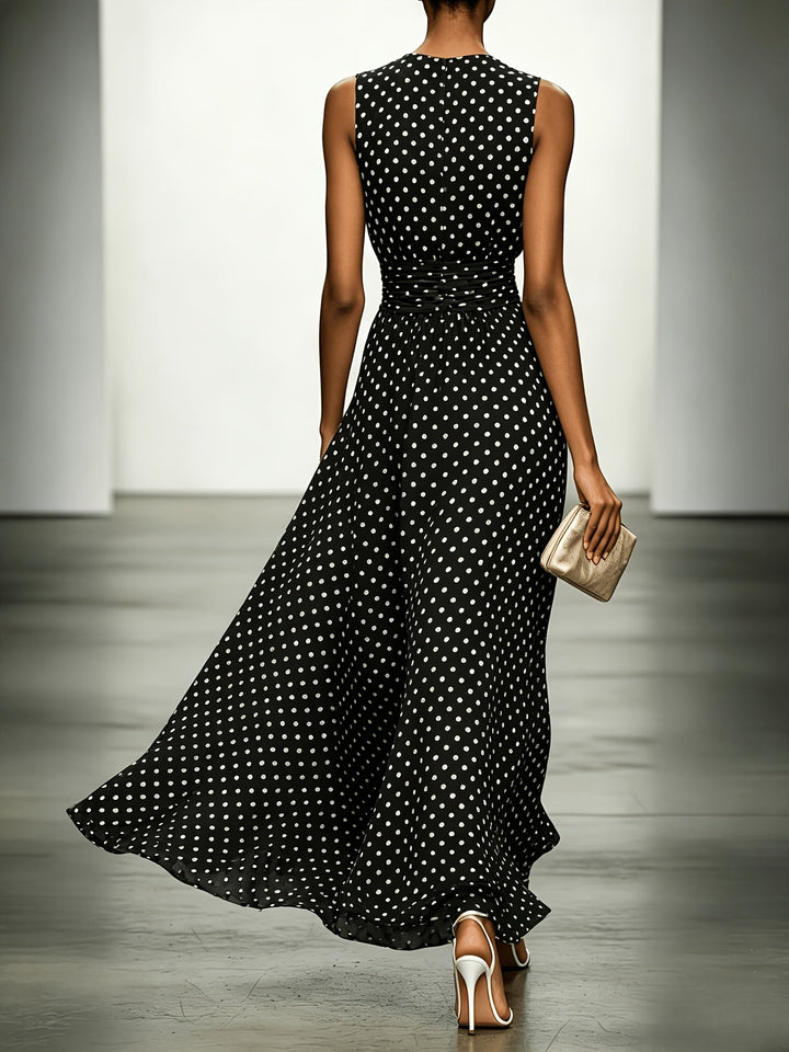 Polka dot maxi dress by Bennett and Lowe, featuring a flowy silhouette and sleeveless design, worn by a model outdoors.