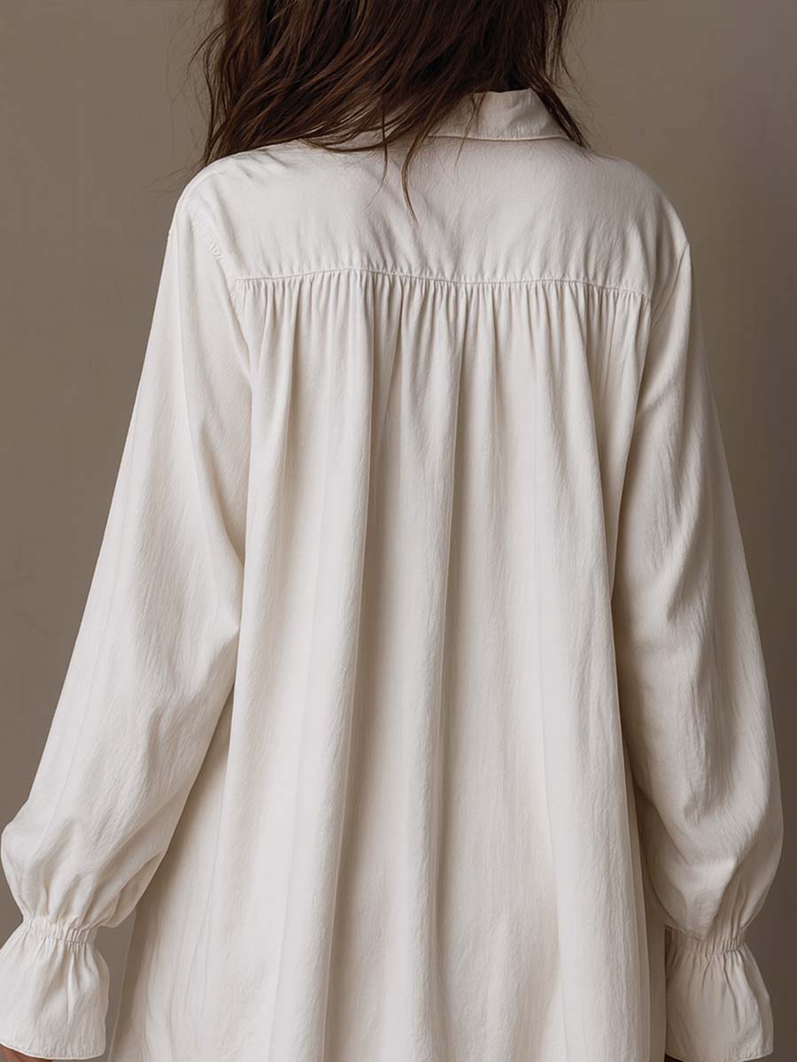 Olivia Newyork Lucia lace detail irregular-hem mini dress with country muse style, displayed on a hanger showing its flowy fabric and intricate lace.