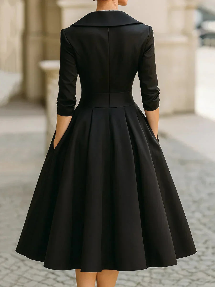 Karen satin wrap-bodice midi dress with collar and pockets, by Bennett and Lowe, shown hanging with a smooth fabric finish.
