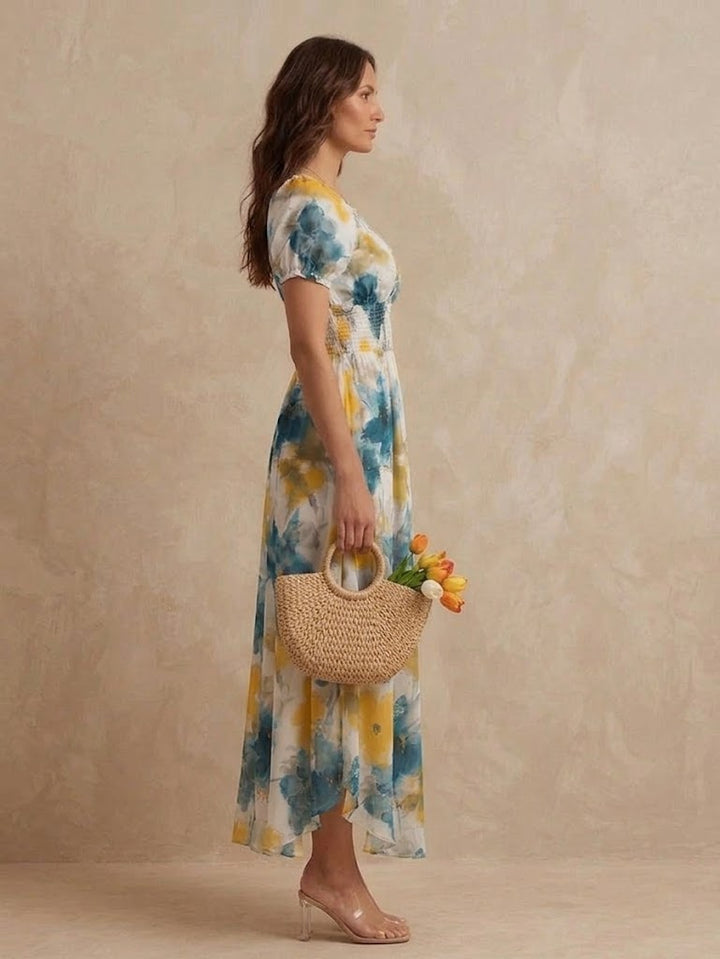 Delphine Bennett and Lowe floral shirred V-neck maxi dress with flowing fabric and floral pattern, displayed on a hanger.