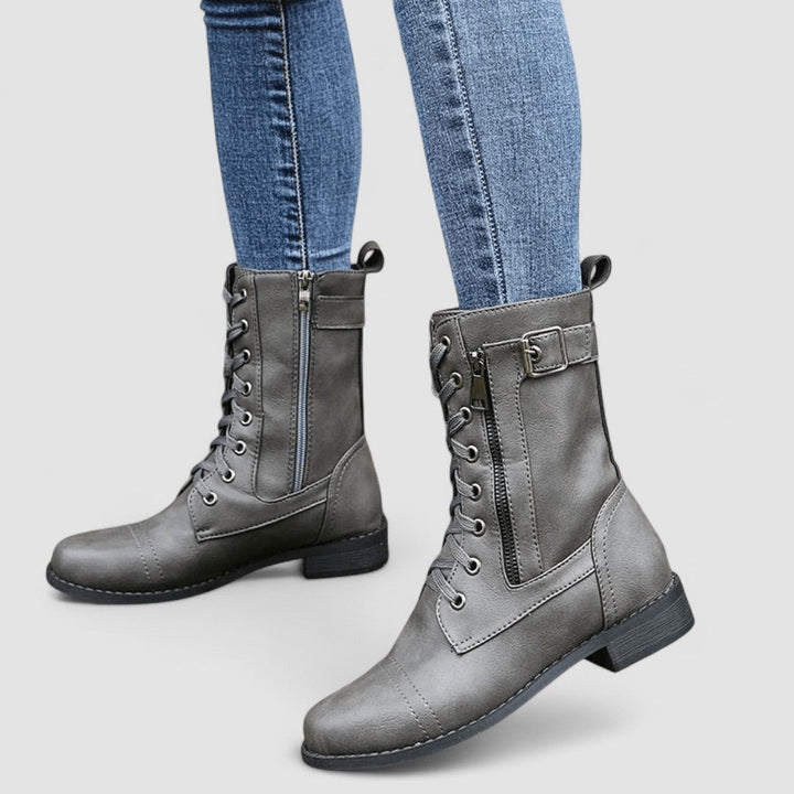 Bennett and Lowe Sylvia lace-up mid-calf women's boots in black leather with chunky heel and decorative stitching.