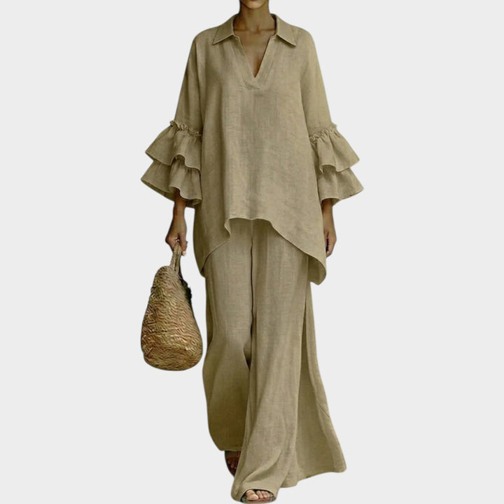 A woman wearing the Ariela oversized top and wide-leg pants two-piece set by Bennett and Lowe, styled casually outdoors.