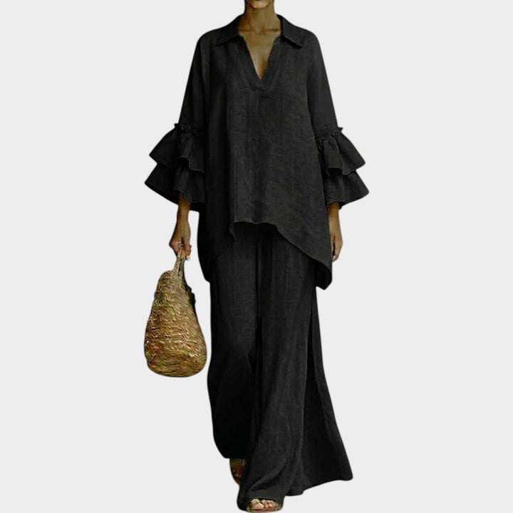 A woman wearing the Ariela two-piece set by Bennett and Lowe, featuring an oversized top and wide-leg pants, in a neutral color.