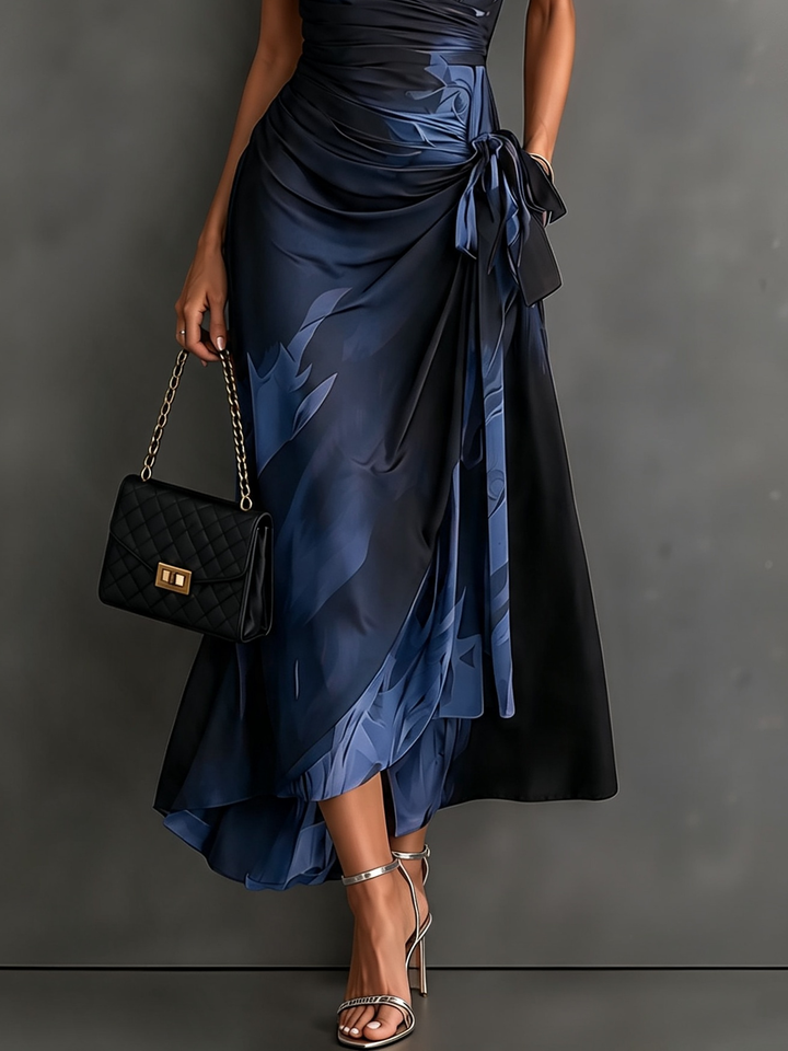 Blue abstract print Bennett & Lowe Camilla midi wrap dress shown on a hanger, highlighting its stylish design and vibrant pattern.