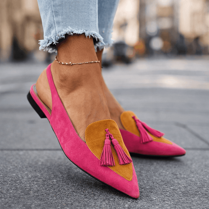 Eliza handwoven tassel flat sandals by Bennett and Lowe featuring beige straps and decorative tassels on a flat sole.