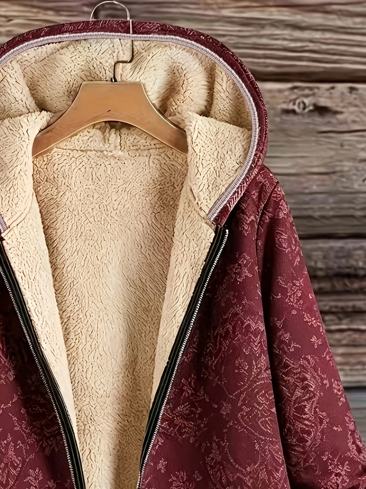Eileen floral hooded longline coat by Bennett & Lowe, featuring a colorful floral pattern and a cozy hood for autumn wear.