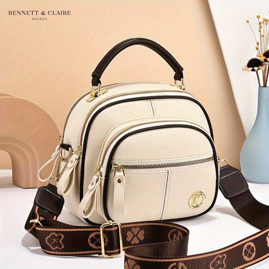 Vivienne compact adjustable crossbody bag by Bennett and Lowe, featuring sleek design and adjustable strap on neutral-colored material.