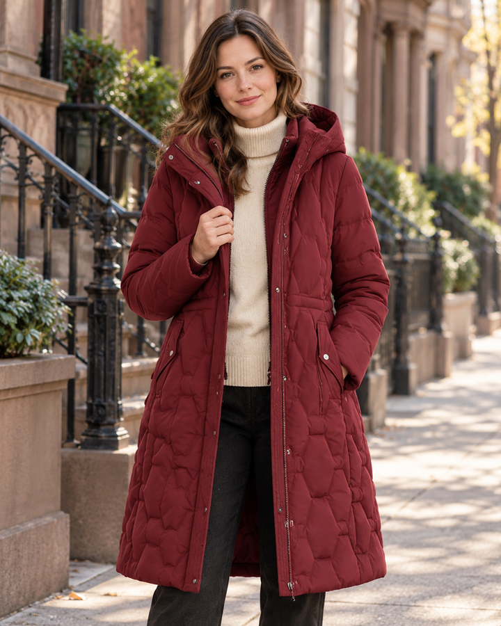 Burgundy longline quilted hooded coat from Bennett & Lowe Jacqueline collection, stylish puffer coat on brownstone street.