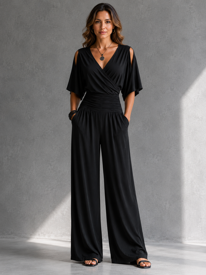 Bennett and Lowe Stella wrap V-neck jumpsuit in black, showing a stylish, fitted design with long sleeves and a waist tie.