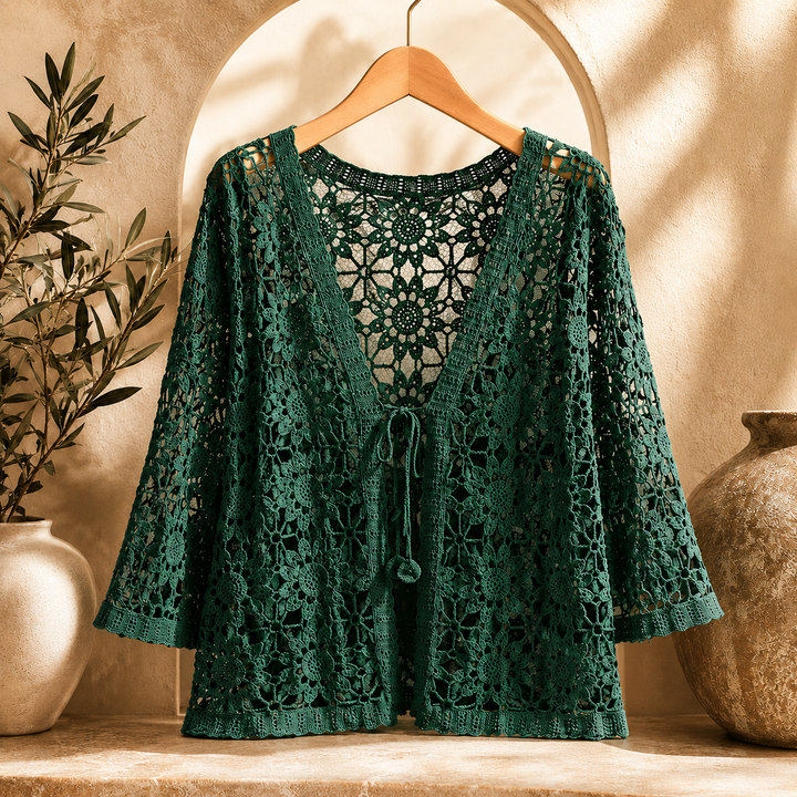 Elora crochet cardigan by Bennett and Lowe, featuring intricate knit detailing and a relaxed fit, displayed on a hanger.