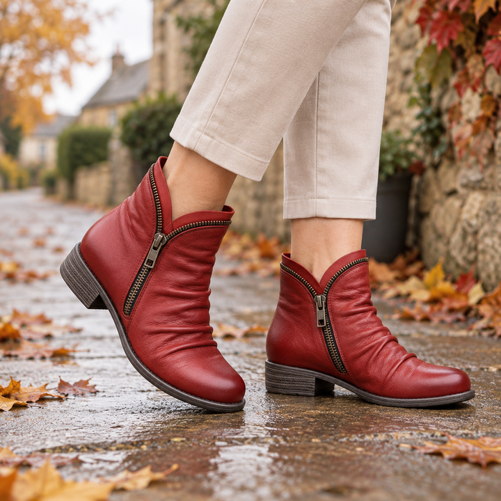 Corinne Bennett and Lowe round-toe ankle boots in black leather, featuring a sleek design and low heel.