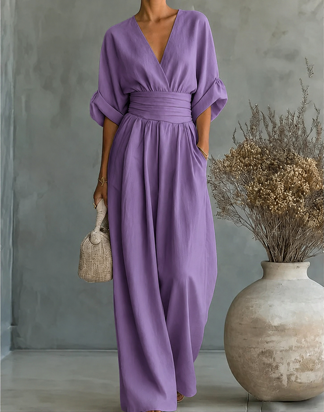 Women's deep V-neck wide-leg jumpsuit by Bennett and Lowe, featuring a stylish, flowing silhouette and elegant design.