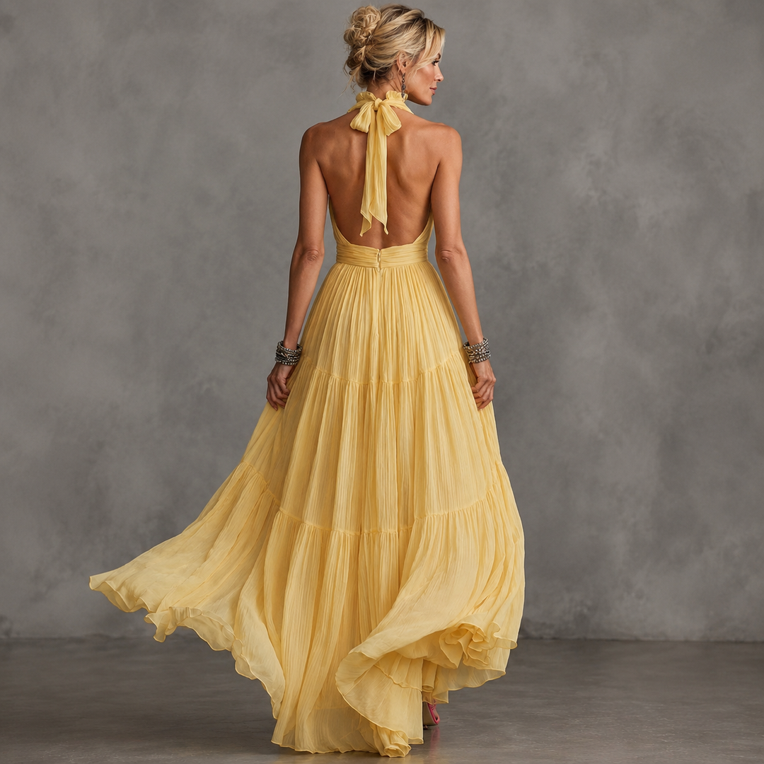 Delphine backless pleated ruffle-trim maxi dress by Bennett and Lowe, flowing fabric, elegant design, and floor-length style.