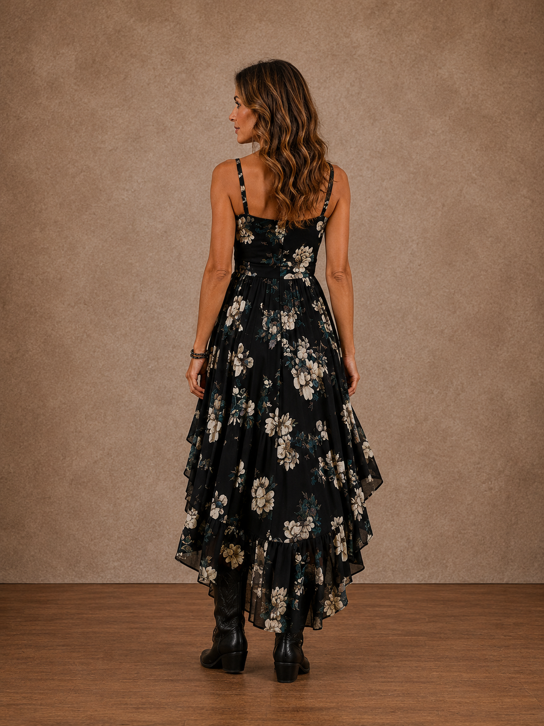 Dark floral Bennett and Lowe Delilah hi-low dress with flowing fabric and ruffled hem, showcased on a model.