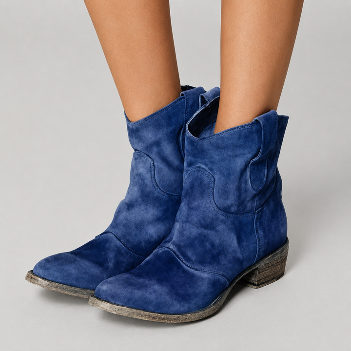 Charlotte Bennett and Lowe comfort suede ankle boots with a rounded toe and low block heel, styled on a casual urban background.