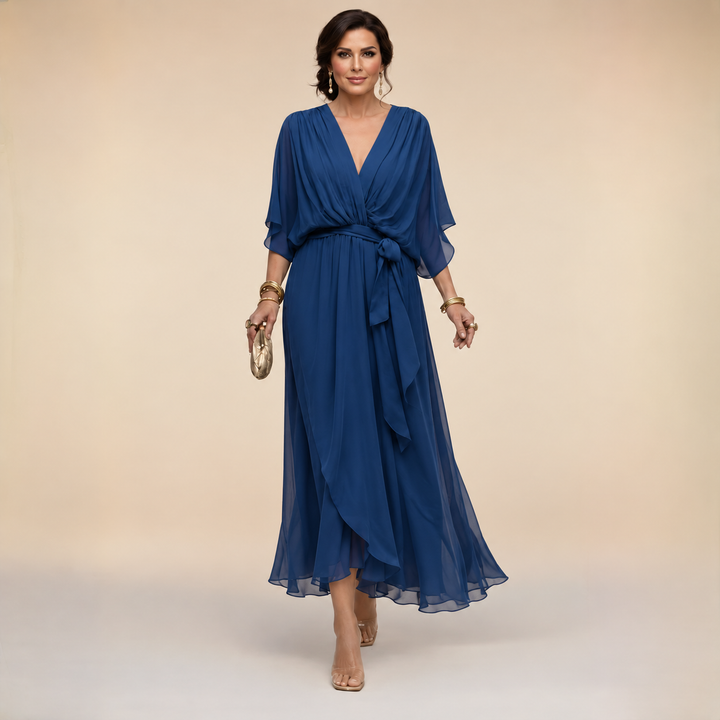 Elegant navy chiffon V-neck dress by Bennett and Lowe, featuring a wrap design and flowing fabric.