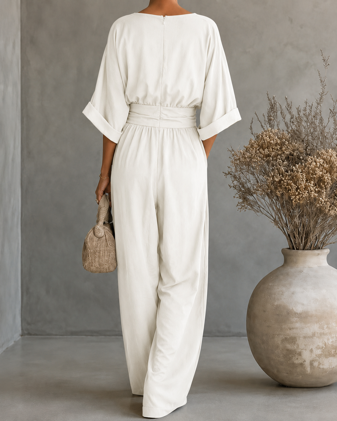 Back view of Bennett and Lowe Elise deep V-neck wide-leg jumpsuit for women in white fabric, showcasing stylish back design.