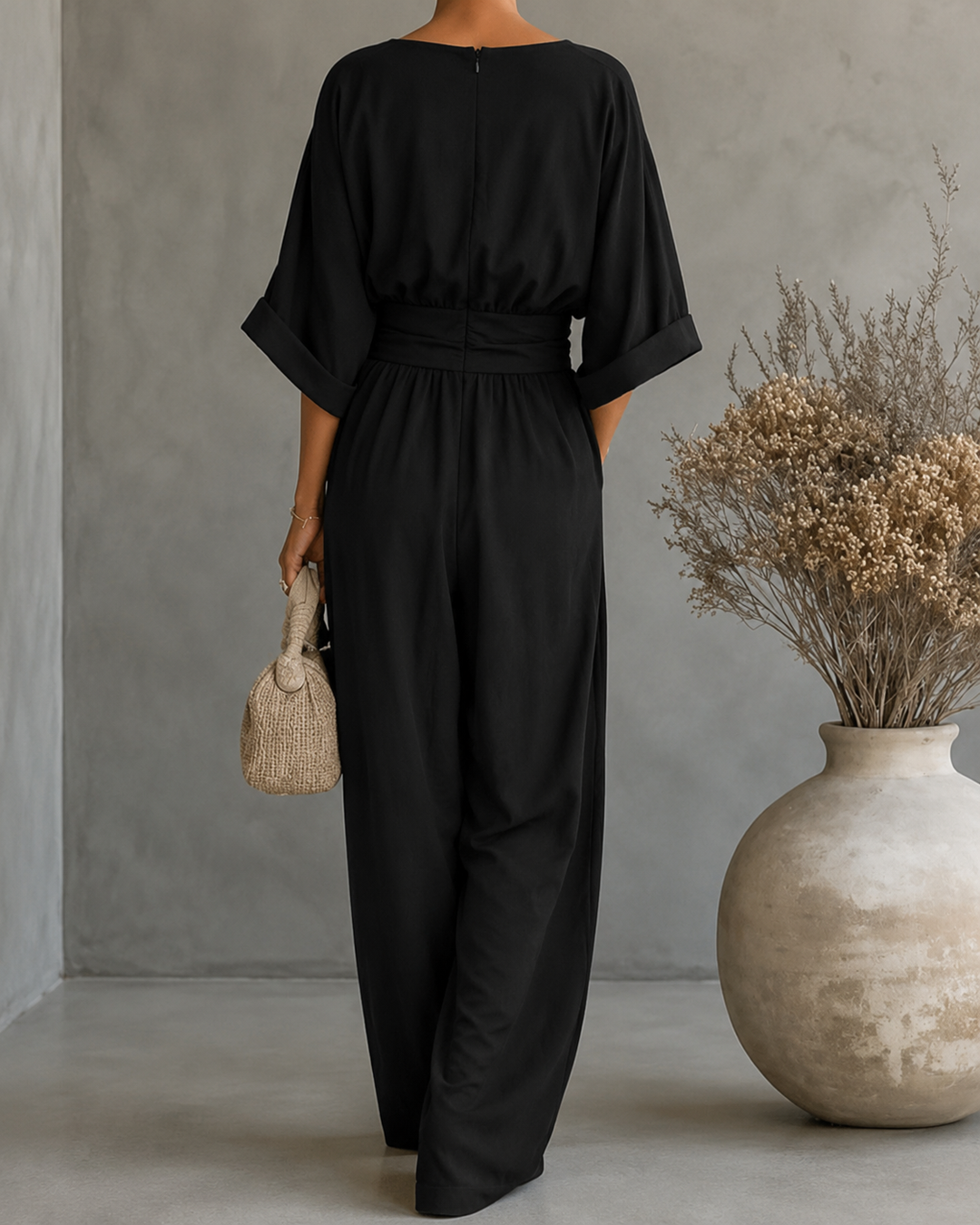 Back view of Bennett and Lowe Elise deep V-neck wide-leg women's jumpsuit in black fabric.