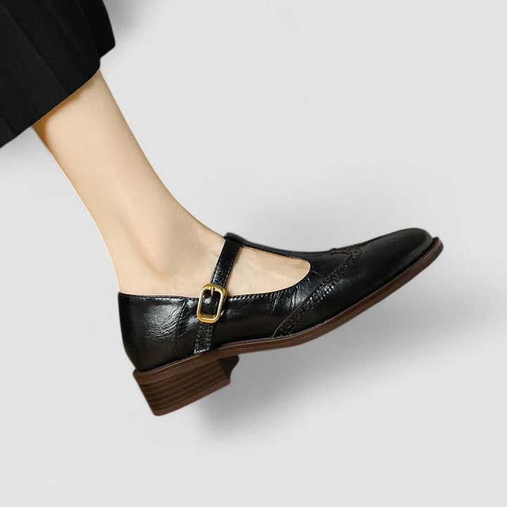 Daisy casual Mary Jane shoes by Bennett and Lowe featuring black leather straps and rounded toe on a wooden floor.