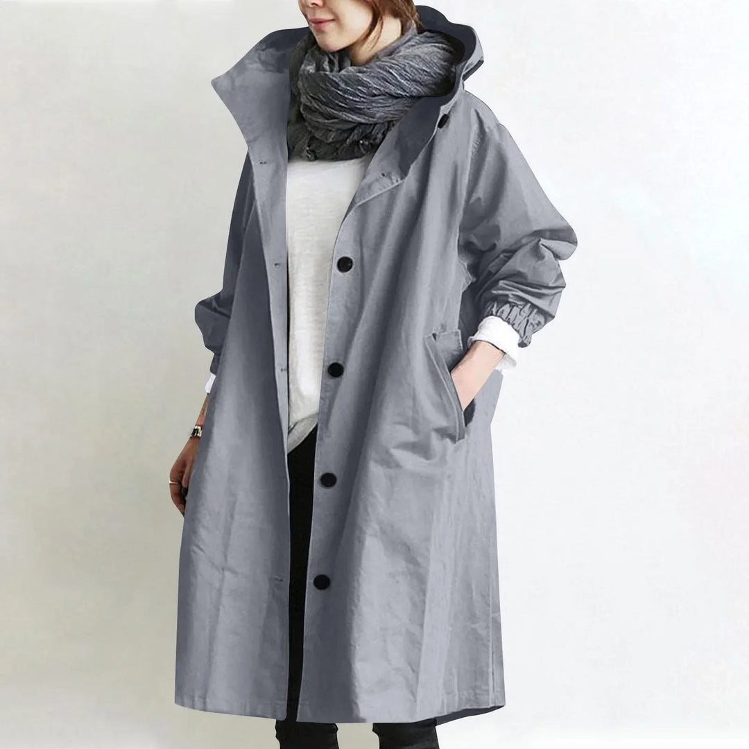Eloise hooded longline trench coat by Bennett and Lowe, shown in dark fabric with a belt and classic collar style.