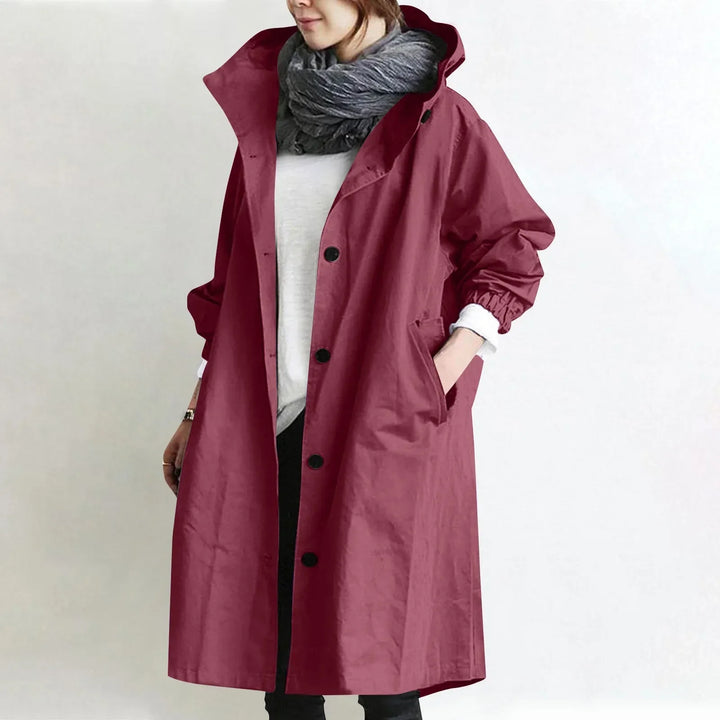 Eloise hooded longline trench coat by Bennett and Lowe, navy blue with adjustable belt and deep front pockets, stylish and versatile outerwear.