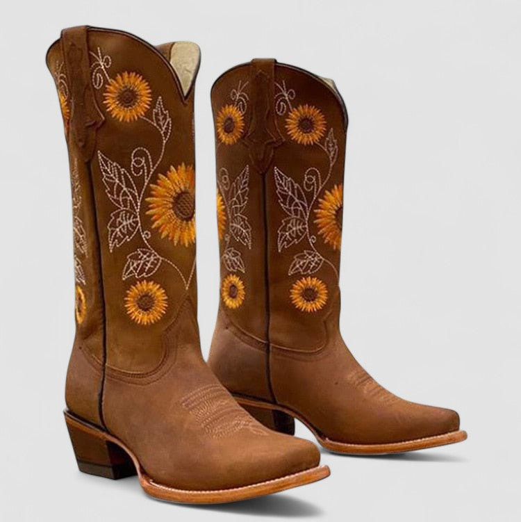 Women's cowboy boot with sunflower and daisy embroidery by Bennett and Lowe, featuring intricate floral embroidery on leather.
