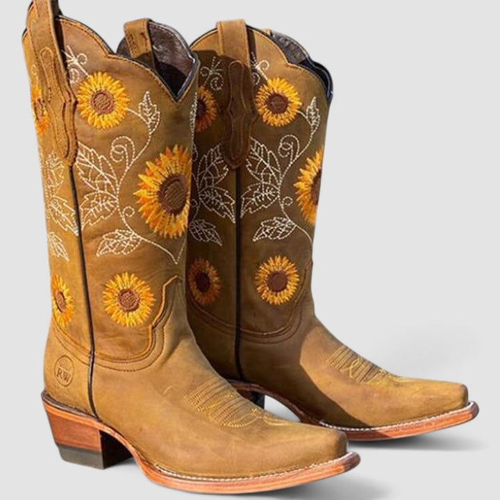 Women's cowboy boot by Bennett and Lowe featuring sunflower embroidery and Daisy design, with leather upper and pointed toe.