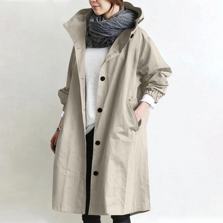 Eloise Bennett and Lowe hooded longline trench coat displayed on a model, featuring a classic silhouette and belted waist.