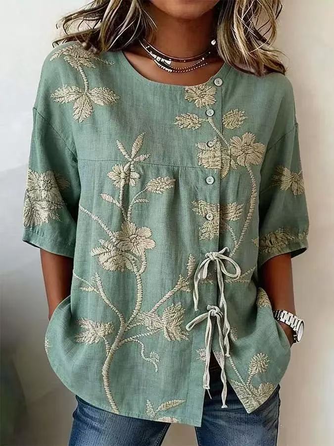 Emeline™ soft embroidered linen top by Bennett and Lowe, featuring delicate embroidery and lightweight fabric, displayed on a hanger.