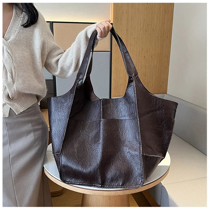 Bennett and Lowe Ruth pebble leather tote bag with adjustable strap, showing the textured leather surface and sleek design.