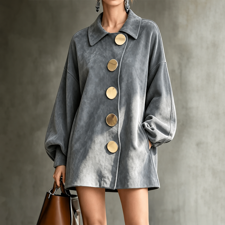 Woman wearing a gray Bennett and Lowe Felicity lapel button mid-length jacket with a matching handbag.