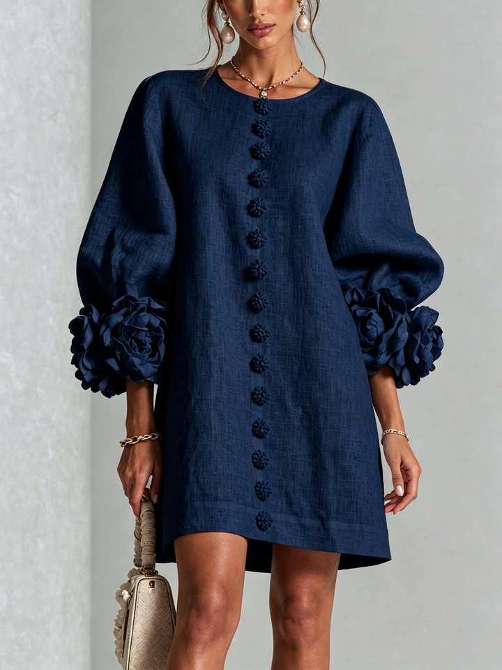 Navy Henrietta™ Floral Button-Down Mini Dress by Bennett and Lowe, featuring a fitted waist, long sleeves, and a floral pattern.