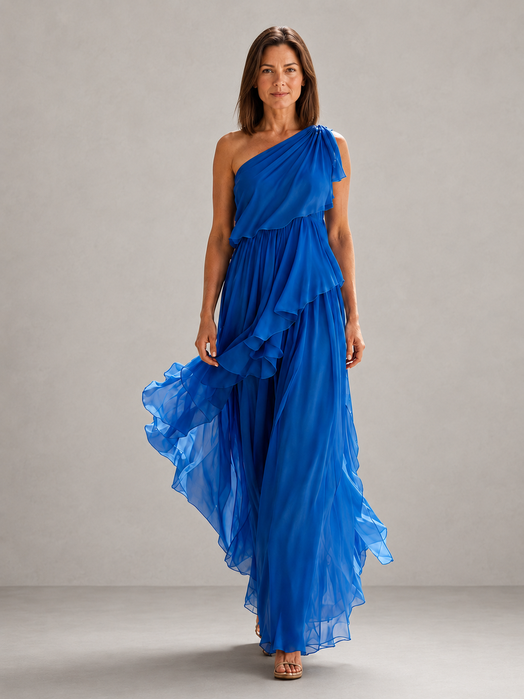 Scarlett Bennett and Lowe one-shoulder ruffle maxi dress with flowing fabric and elegant design in soft pastel color.
