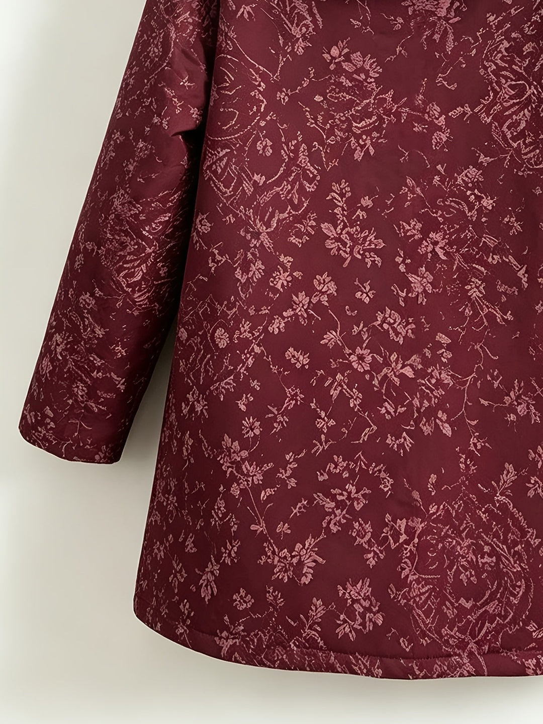 Eileen floral hooded longline coat by Bennett & Lowe, shown in a stylish floral print with a hood and extended length for warmth