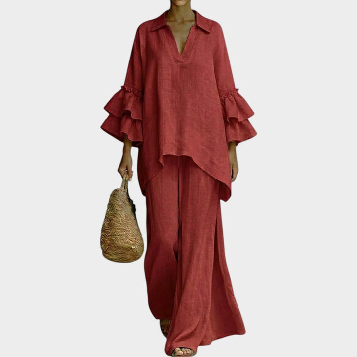 A woman wearing the Ariela oversized top and wide-leg pants two-piece set by Bennett and Lowe, featuring neutral tones and relaxed fit.