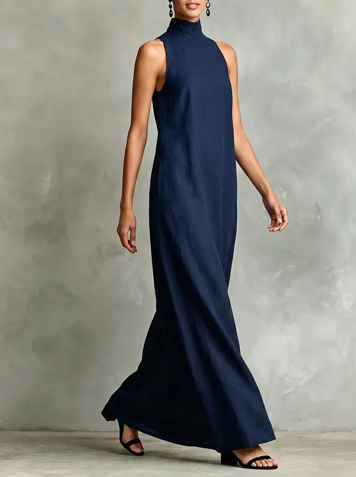 Chrissy Bennett and Lowe high-neck pocket maxi dress in a flowing fabric, shown in a relaxed pose.