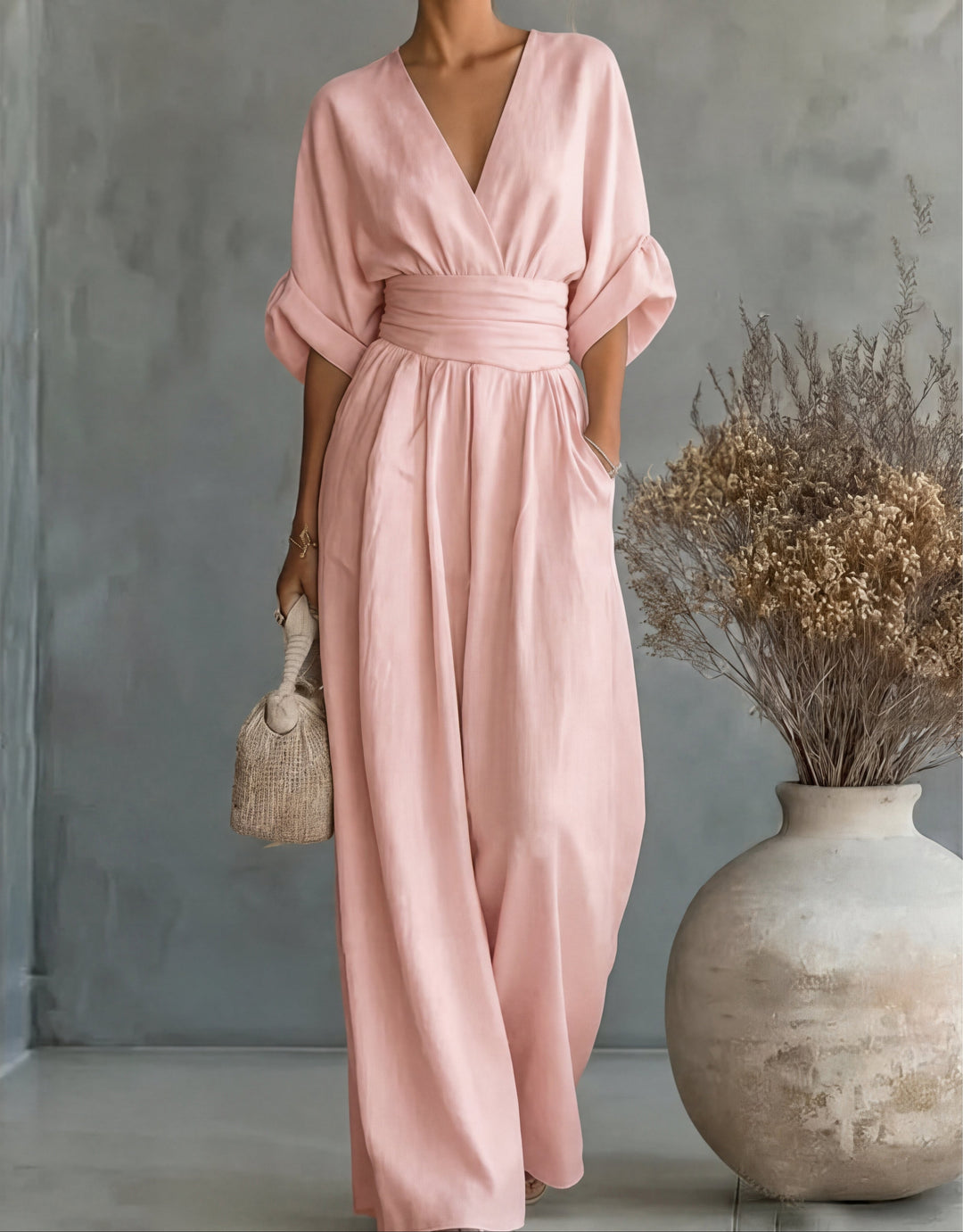 Bennett and Lowe Elise deep V-neck wide-leg jumpsuit for women, shown in a neutral color with flowing fabric and a fitted waist.
