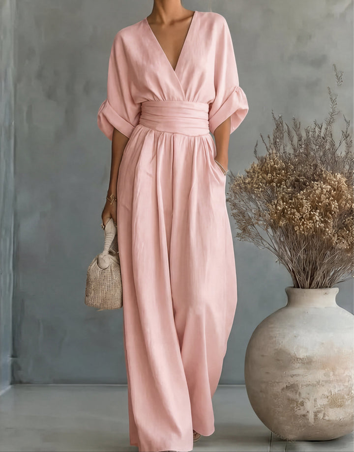 Bennett and Lowe Elise deep V-neck wide-leg jumpsuit for women, shown in a neutral color with flowing fabric and a fitted waist.
