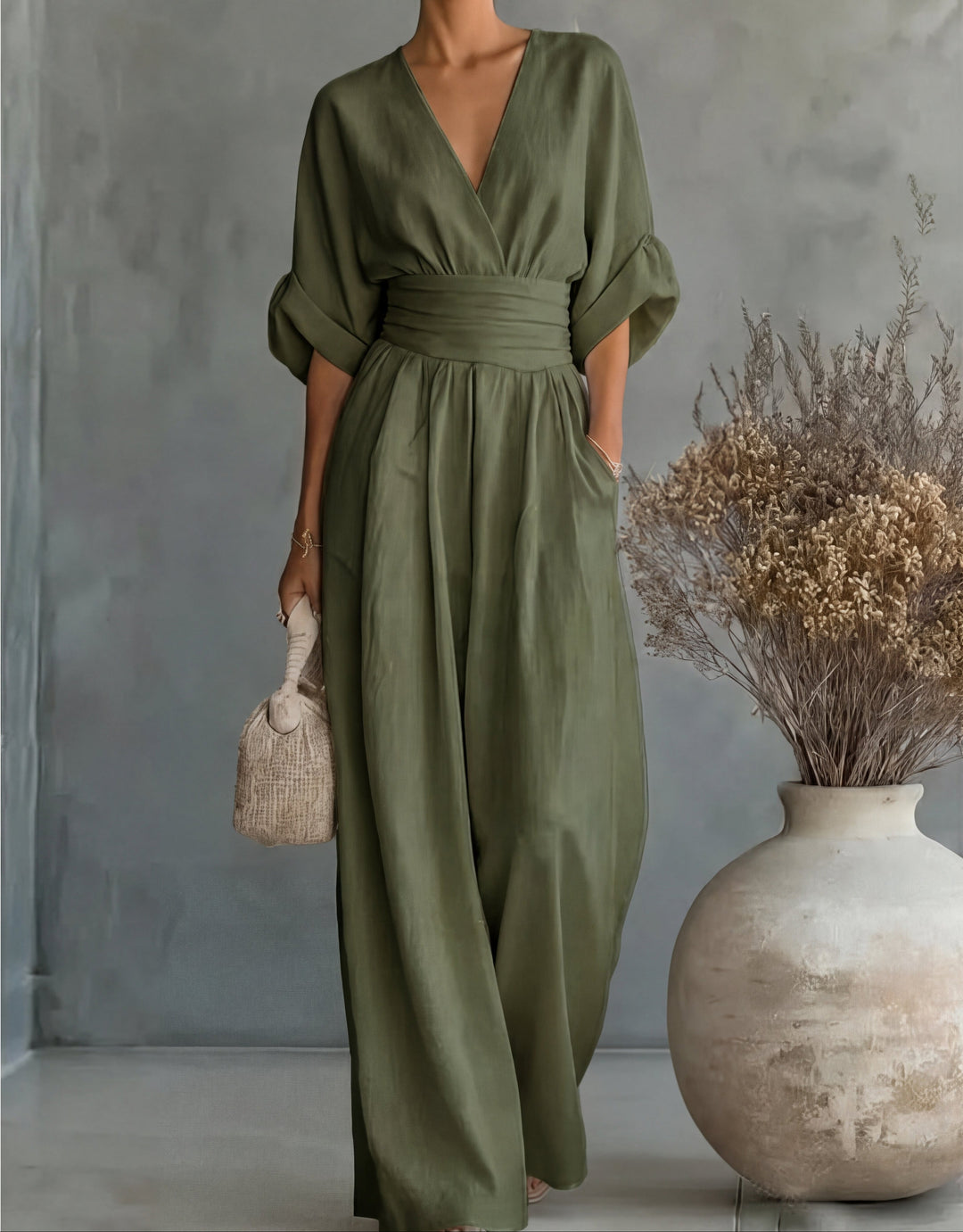 Woman wearing Bennett and Lowe Elise deep V-neck wide-leg jumpsuit, showcasing its stylish fit and flowing fabric.