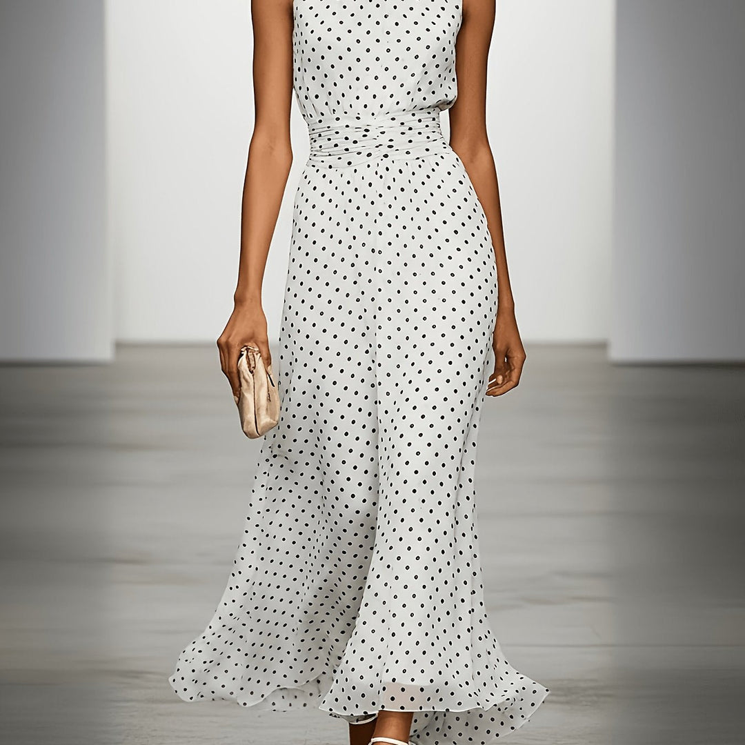 Bennett and Lowe Colleen polka dot maxi dress with sleeveless design and flowing fabric on a model outdoors.