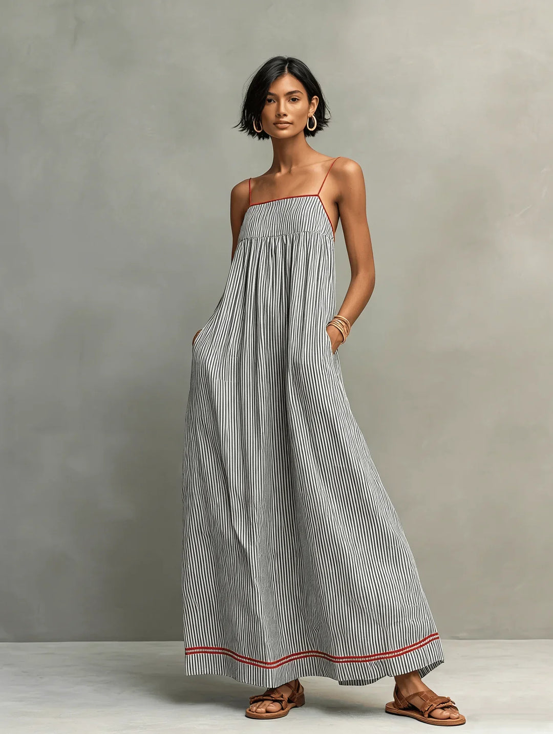 Celina Bennett and Lowe striped contrast-trim maxi dress with thin shoulder straps, flowing fabric, and bold pattern.