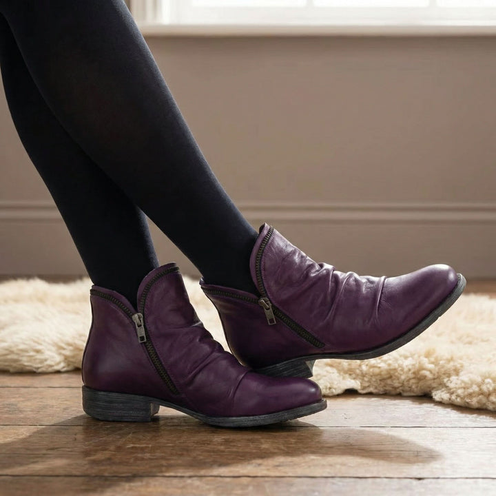 Corinne Bennett and Lowe round-toe ankle boots with sleek design and ankle height, shown in a stylish leather finish.