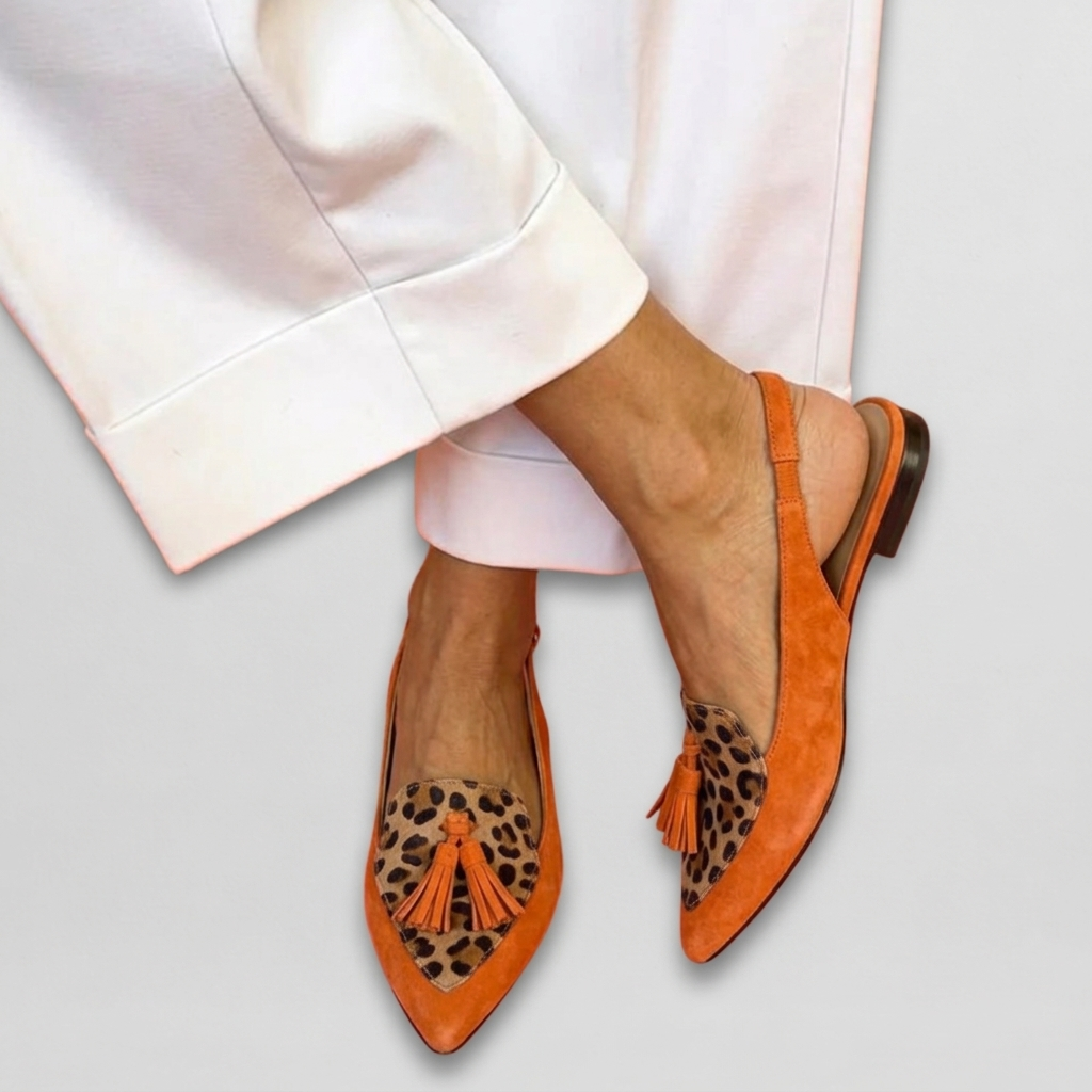 Eliza Bennett and Lowe handwoven tassel flat sandals with colorful woven straps and tassel accents on a neutral background.