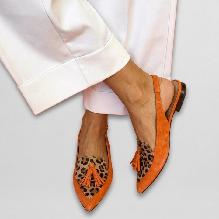 Eliza Bennett and Lowe handwoven tassel flat sandals with colorful woven straps and tassel accents on a neutral background.