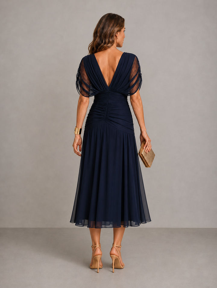 Willow pleated flowing midi dress by Bennett and Lowe, shown in a graceful, flowing fabric with a fitted bodice and pleated skirt.