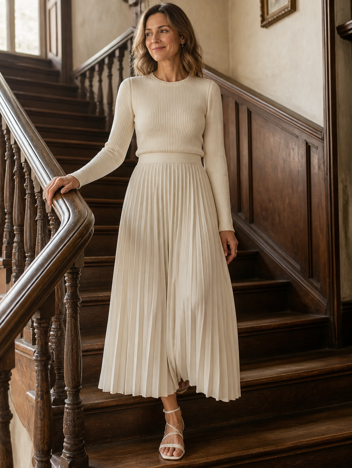 Charlotte ribbed knit pleated midi dress for women by Bennett and Lowe, featuring a fitted bodice, pleats, and a flowing skirt.
