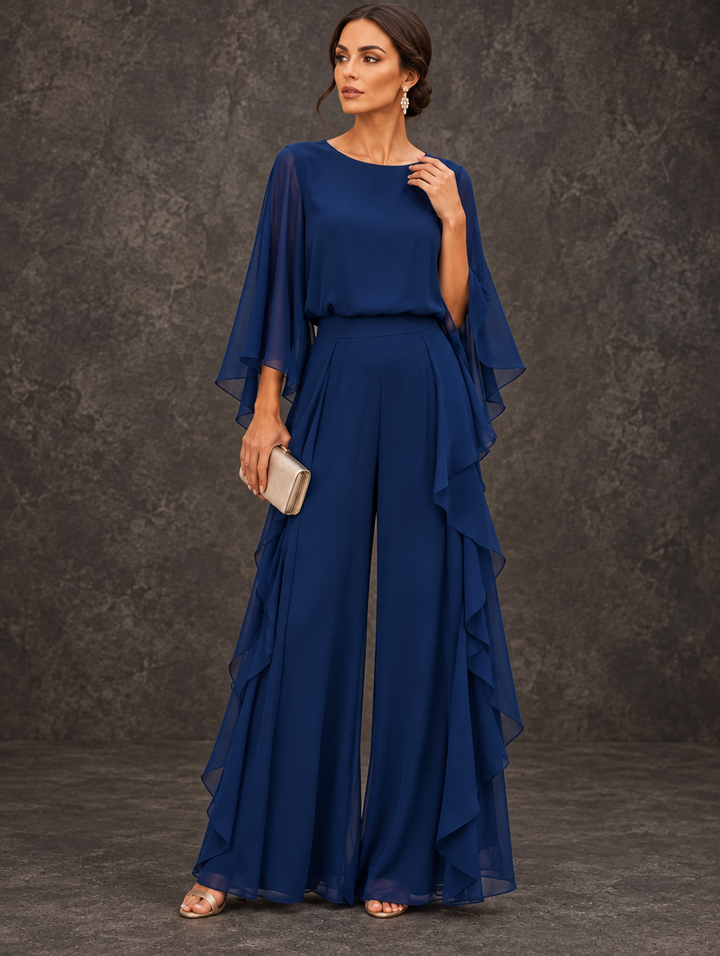 Gloria two-piece set by Bennett & Lowe featuring a cape-sleeve top and ruffle skirt, displayed on a neutral background.