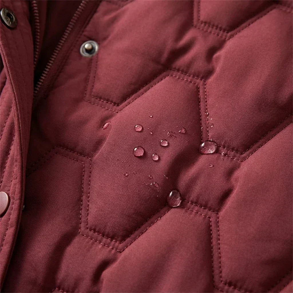 Jacqueline Bennett & Lowe longline hooded quilted coat shown on a hanger, featuring a padded design and a hood for warmth and style.