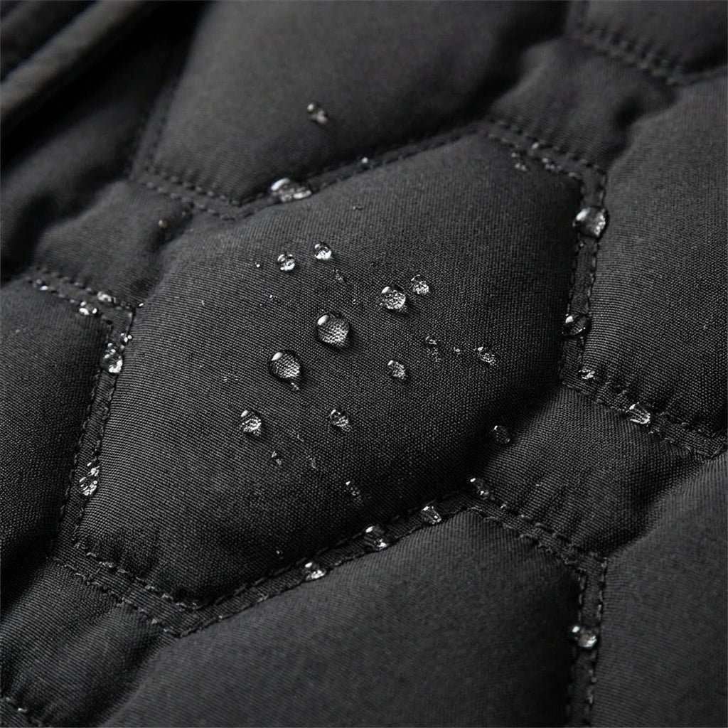 Jacqueline longline hooded quilted coat by Bennett & Lowe, shown in dark grey with a front zipper and oversized fit.